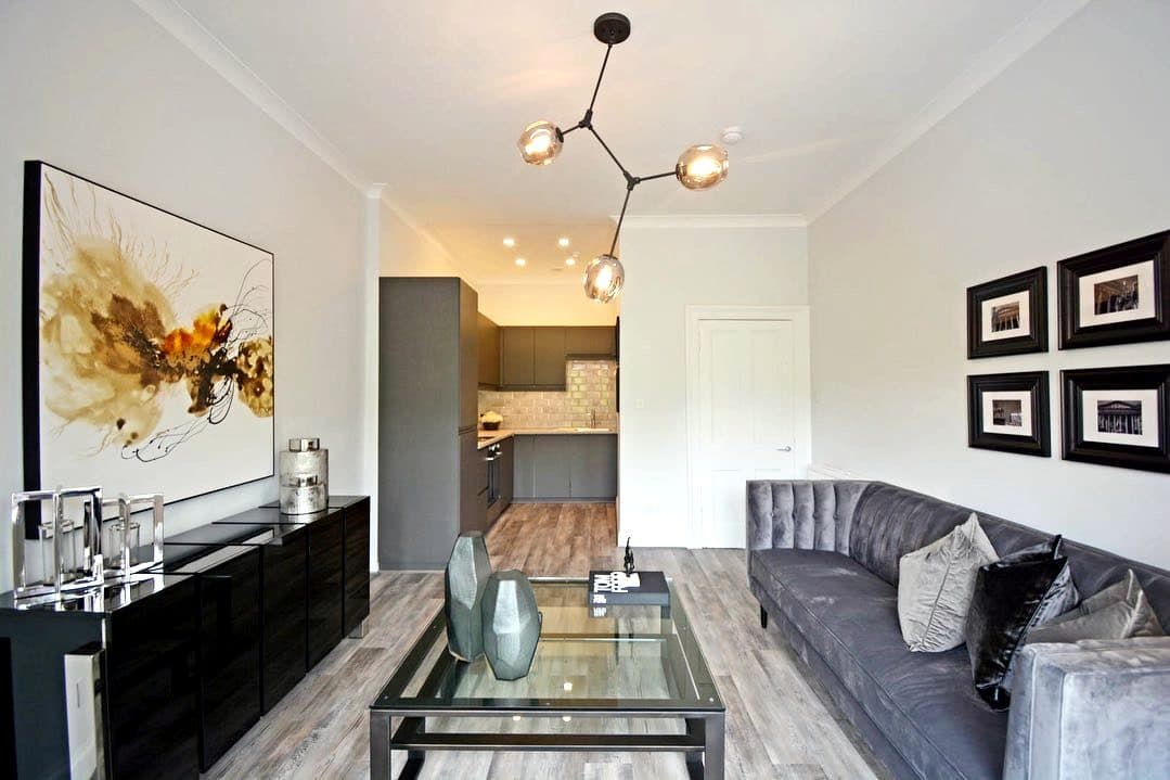 Refitted living room with open-plan kitchen beyond