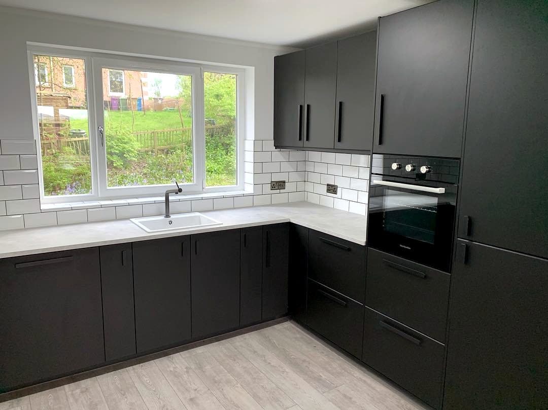 Matt black kitchen with white metro tiled splashback