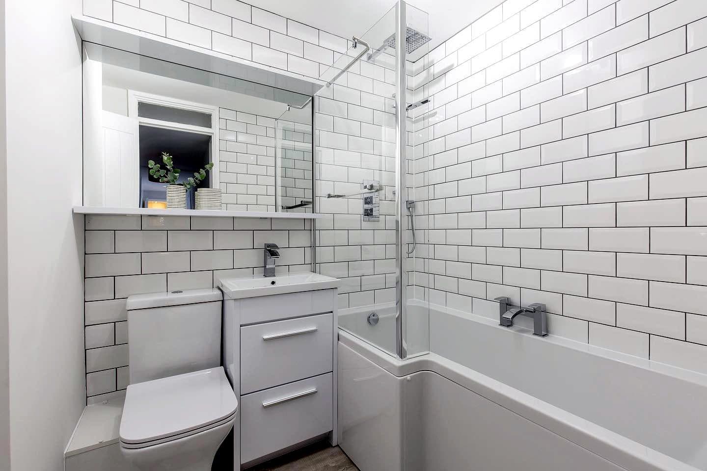 White metro tiled bathroom with shower bath