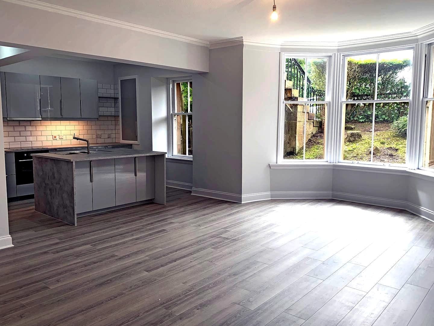 Open-plan room with kitchen island and bay windows